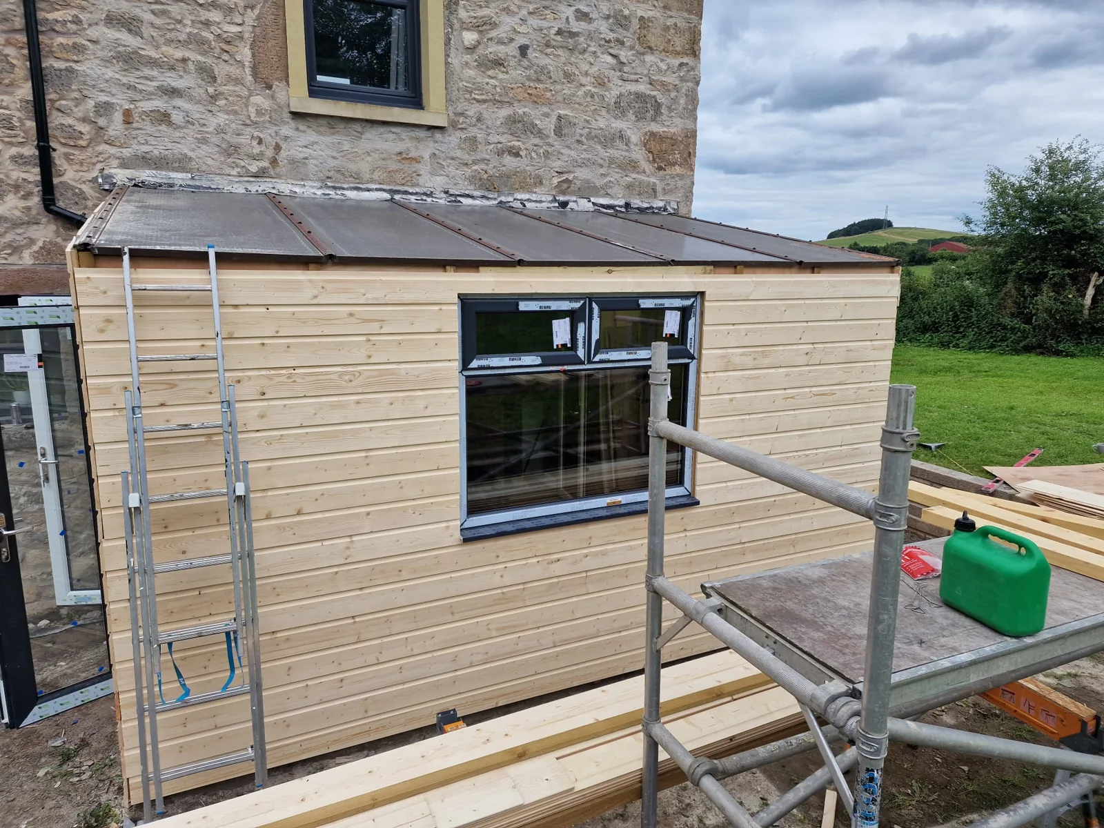 Timber-clad extension with doors